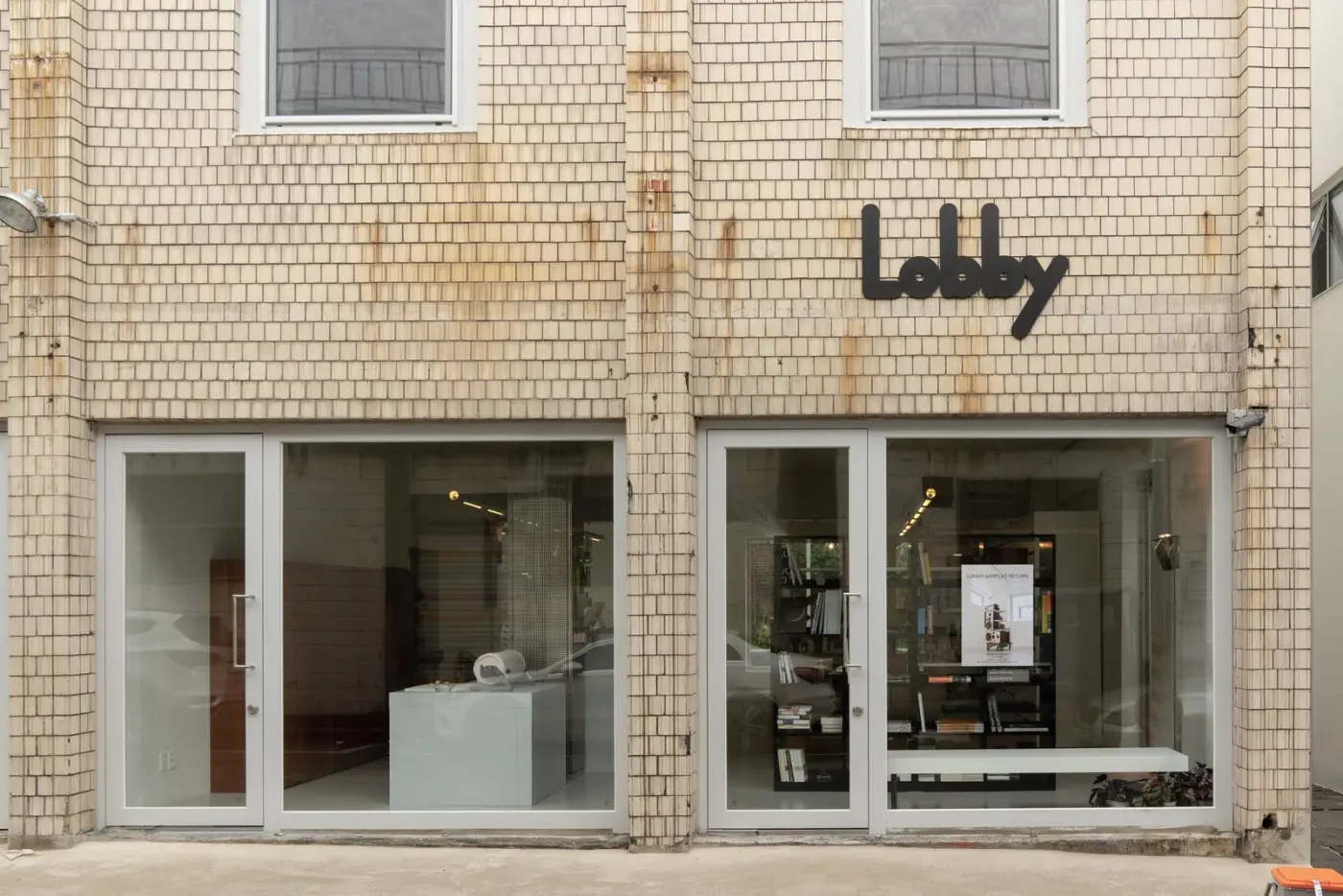 Storefront with a tiled facade and large glass display windows