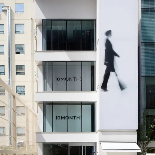 White building with a walking silhouette and 10MONTH lettering