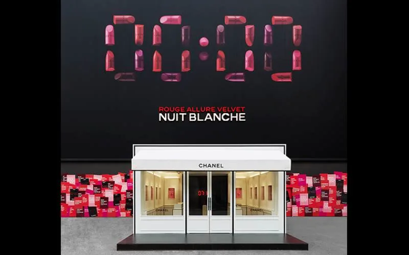 Chanel pop-up storefront in front of a lipstick '00:00' clock graphic