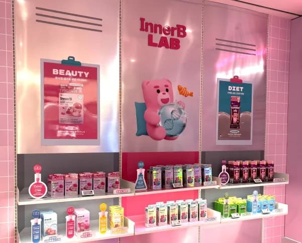 Pink display wall with a character and products