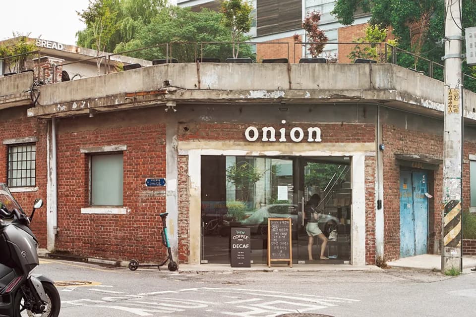 Onion Seongsu exterior with an 'onion' sign on a red-brick corner building