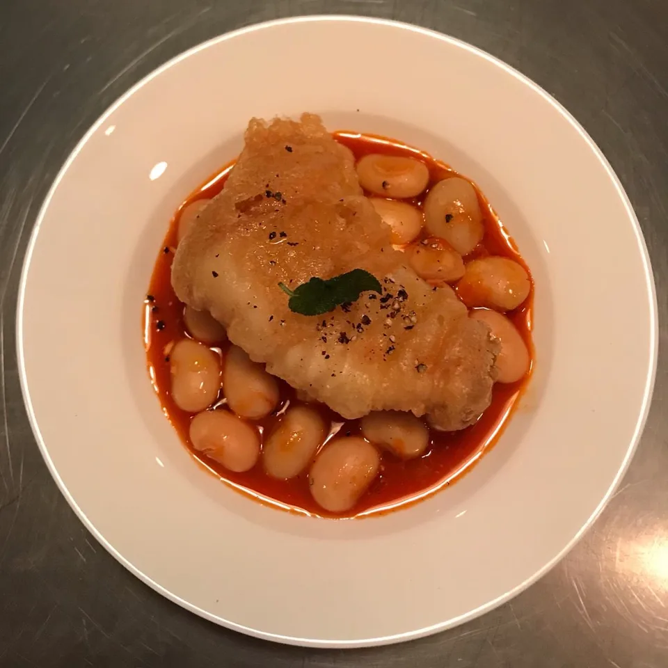 A dish at Sage: fried fish over white beans in tomato sauce