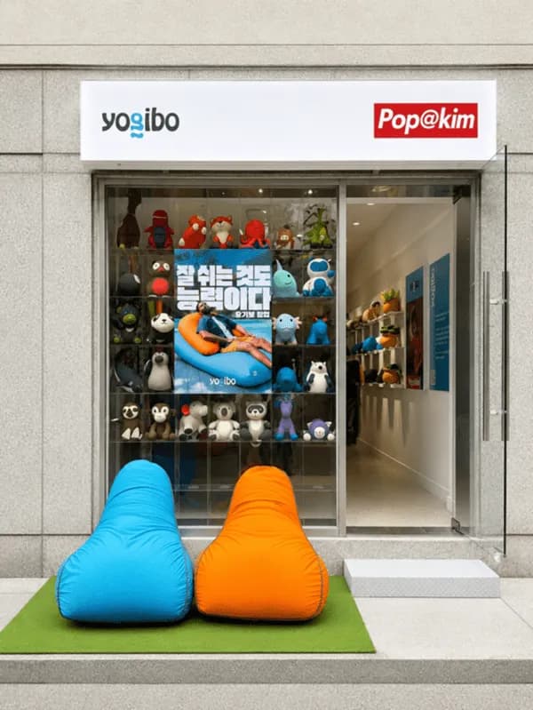 Blue and orange bean bags on artificial turf in front of the store